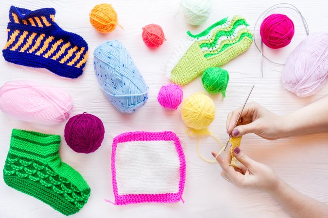 Woman knitting colorful socks