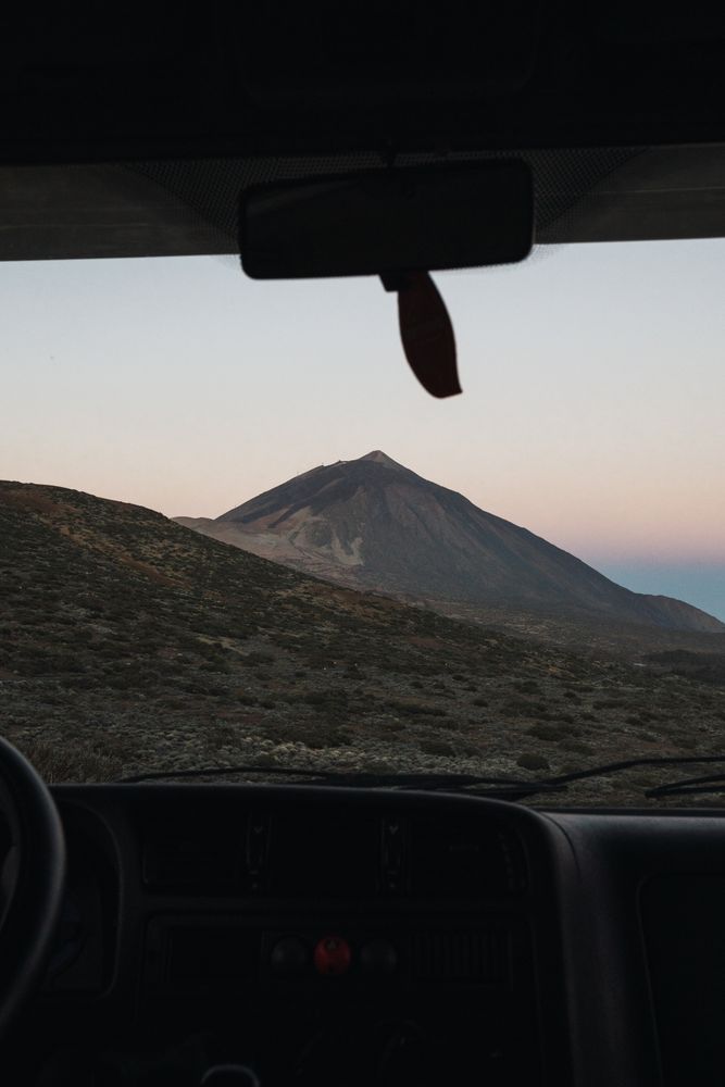 View of mountain through window of car