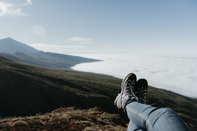 Tourist resting on top of hill