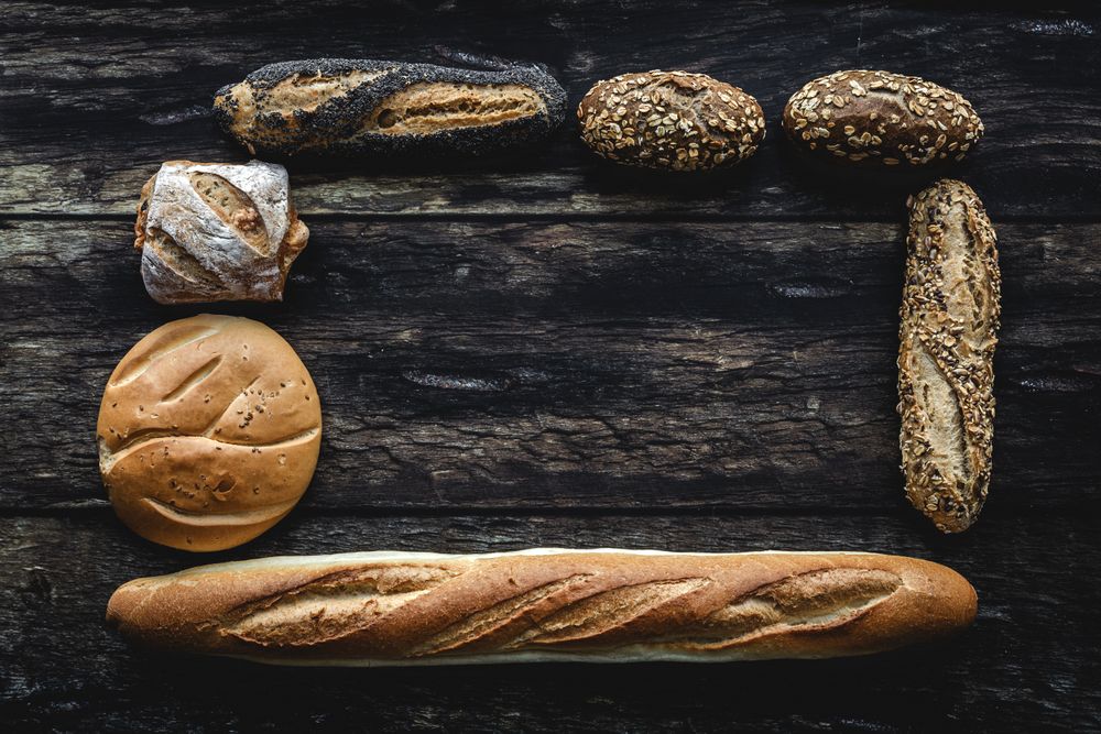 Assorted gold homemade bread on dark wood background