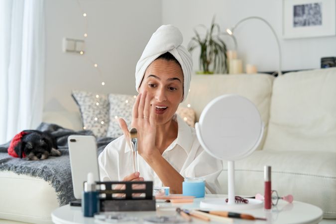Delighted female blogger recording beauty blog
