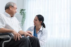 Mature man joking with medical professional