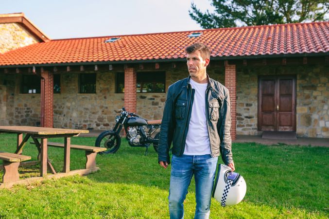 Man posing and custom motorcycle in background