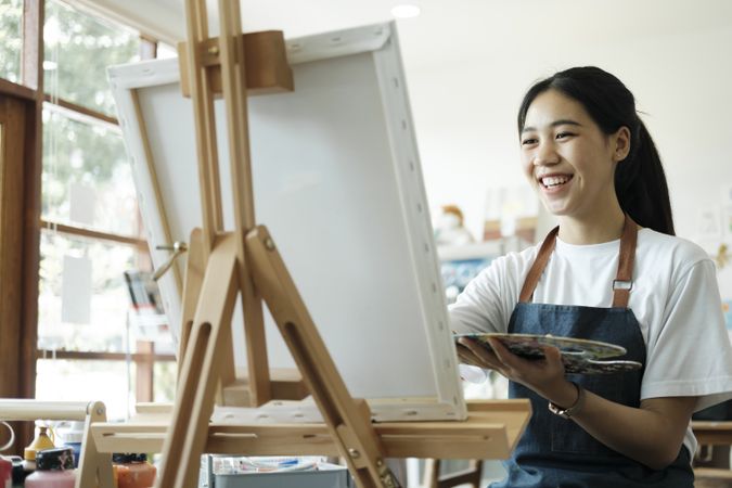 Crafting Inspiration. Female Artist Sketching and Painting in Workshop