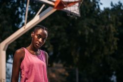 Confident female basketball player on the court