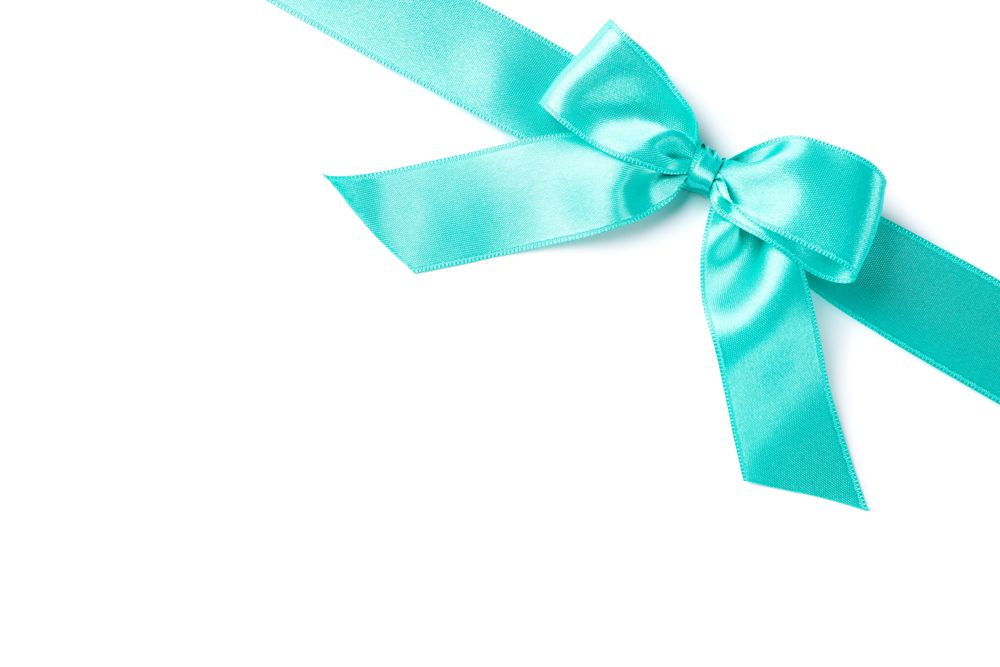 Turquoise ribbon with bow isolated on plain background. Gift concept