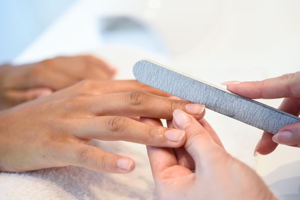 Beautician working on a client’s nails