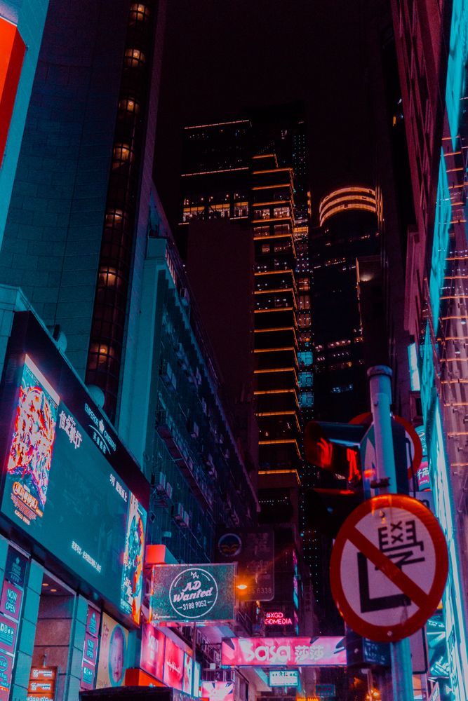 Low -angle view of lit skyscraper during night time