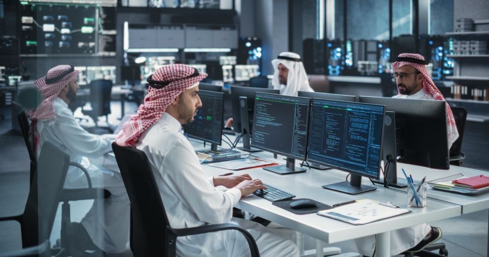 Computer Screens with Software Code and Technical Neural Network Diagrams in Muslim Office