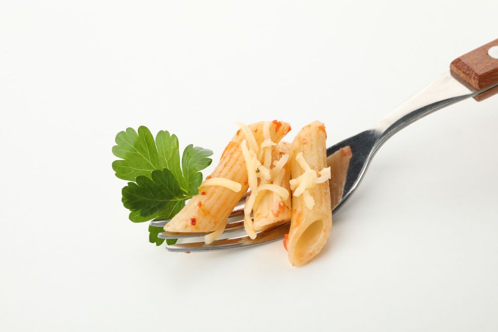 Fork with tasty pasta isolated on blank background
