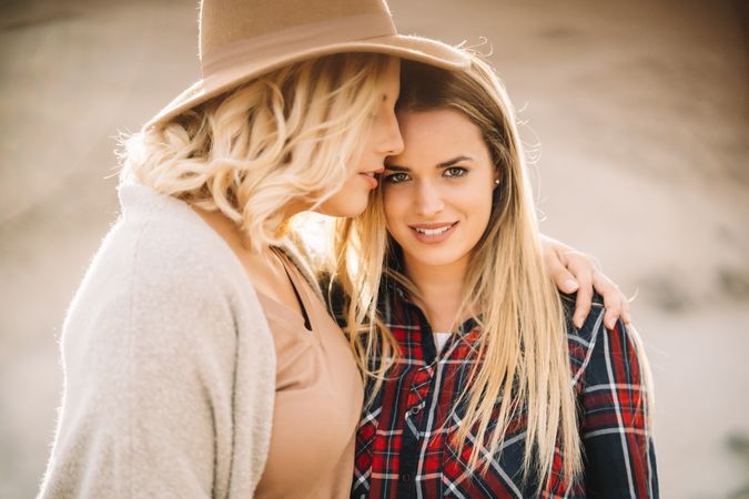 Content blond women cuddling on nature