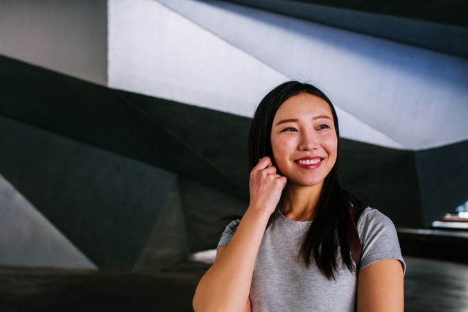 Cheerful Asian woman looking away