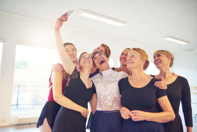 Group of happy women take selfie in bright dance studio