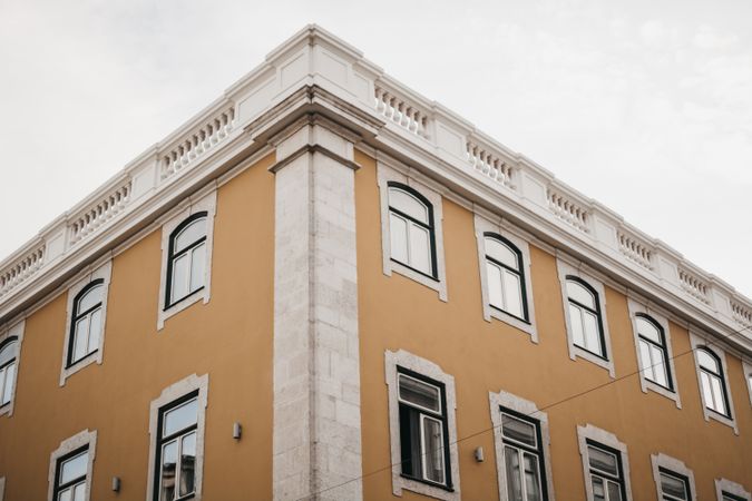 Corner of building against cloudy sky