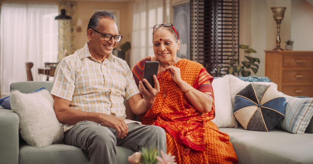 Mature Couple Using Smartphone for Video Call at Home