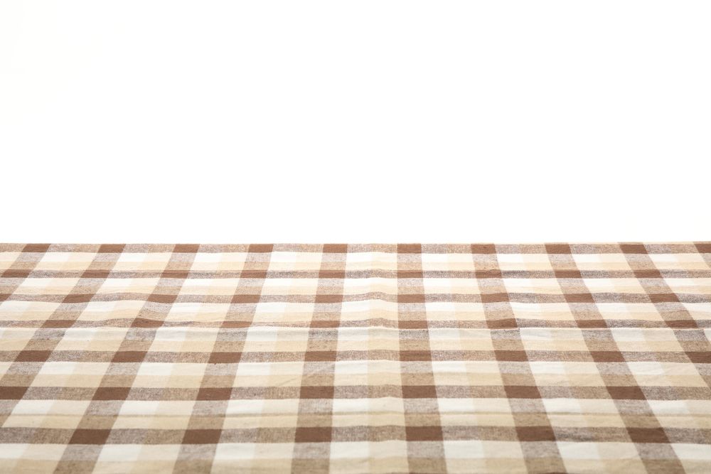 Checkered napkin against studio background, space for text