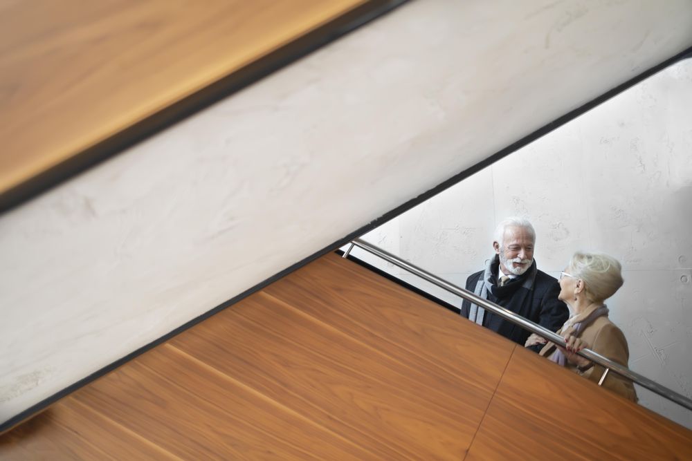 Mature couple going up an escalator
