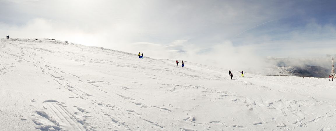 People having fun on snowy mountains in Sierra Nevada