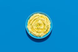 Mashed potatoes above view on a blue background