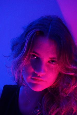 Portrait of teenage girl in neon lit studio