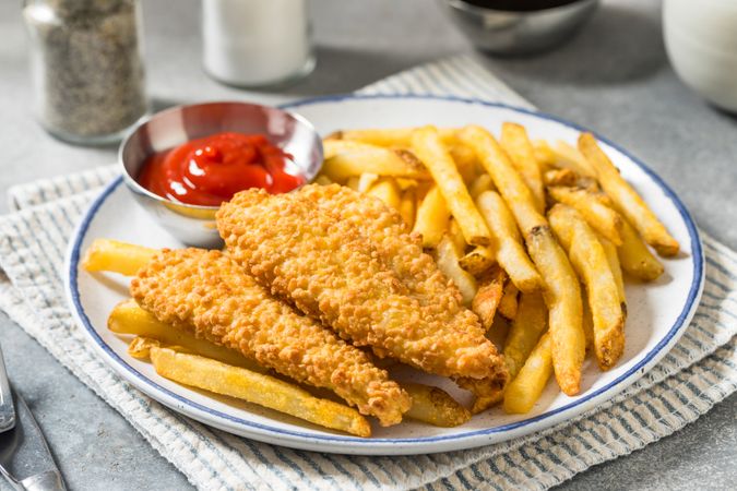 Deep Fried Tender Chicken Fingers and French Fries