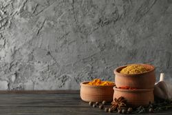 Wooden bowls stacks full of spices with copy space