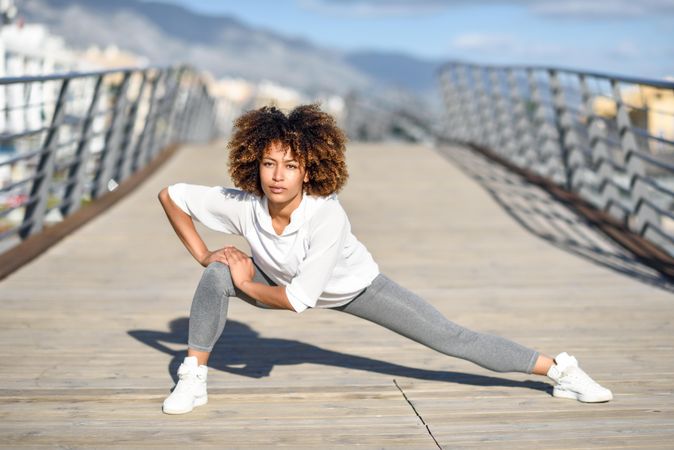 Woman stretching legs on bridge