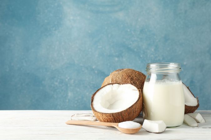 Coconut and milk on wooden background. Tropical fruit