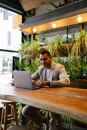 Man working on laptop at cafeteria