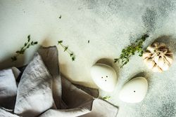 Top view of salt and pepper shakers and garlic on marble background with copy space