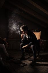 Men with guitar, cigarette and smartphone sitting on chairs