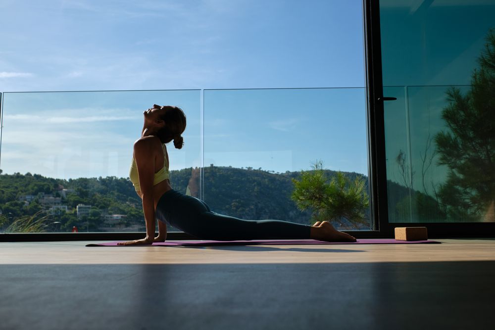 Flexible woman doing yoga in Cobra pose