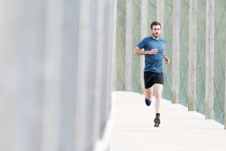 Sportsman jogging outdoors under cover