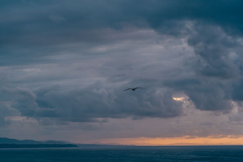 Gray clouds on sundown sky over sea