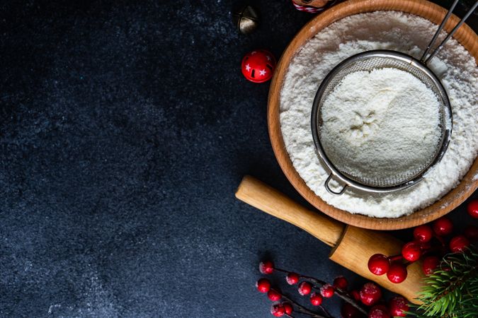 Top view of bowl of flour with sieve for Christmas baking on counter with copy space