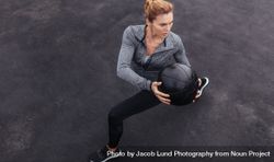 Fit woman exercising outdoors with medicine ball 5ng62Q