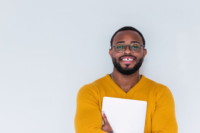 Smiling Black man with laptop