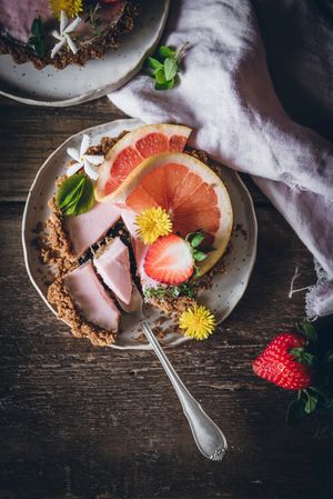 Strawberry and citrus cake served on wooden table
