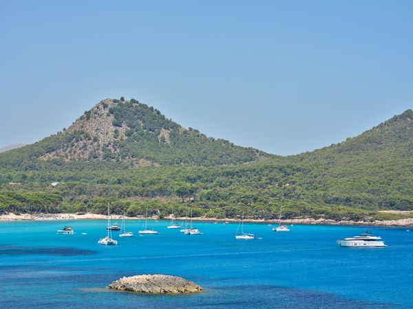 Picturesque scenery of boats on sea against mountain