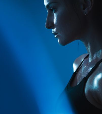 Cropped shot of fit woman sweating looking down