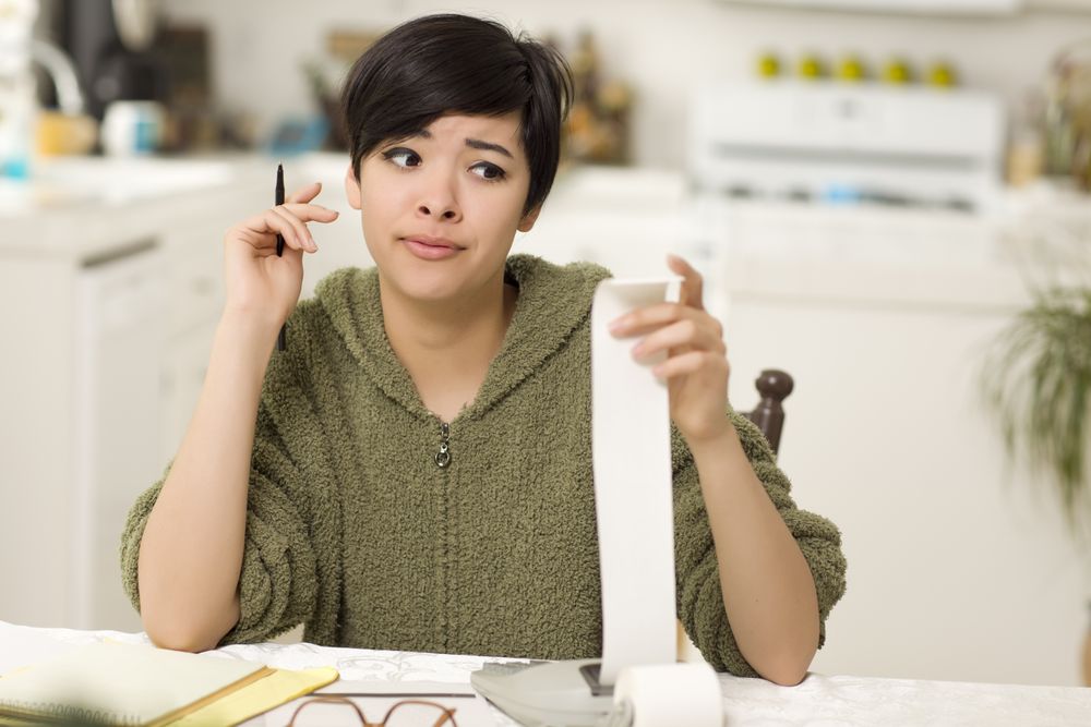 Young Woman Agonizing Over Financial Calculations