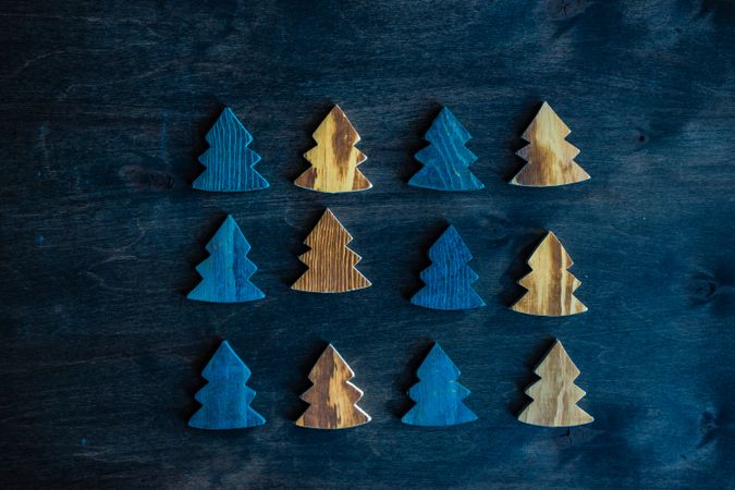Wooden tree blue and golden ornaments on wooden table