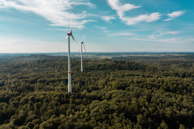 Drone shot with wind turbine in the middle of the forest, in Baden Wurttemberg region, Germany
