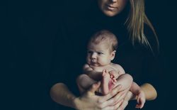 Baby posing in her mother's arms