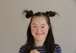 Excited young child smiling at camera