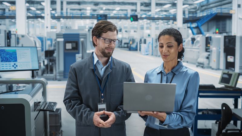 Man and woman looking over laptop in store