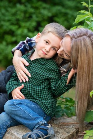 Young mother spending time with son in backyard