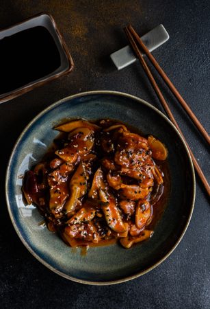 Traditional Chinese sweet and sour pork served with chopsticks