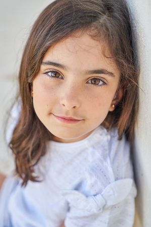 Charming unemotional girl looking at camera
