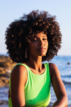 dreamy Black woman standing in sea during summer vacation